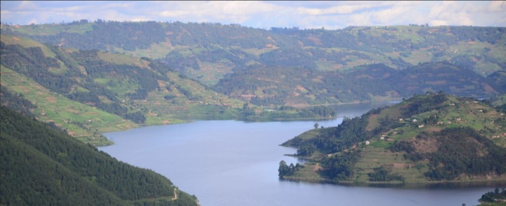 Aerial view of Lake Bunyonyi's islands with green terraced hills and dugout canoes.