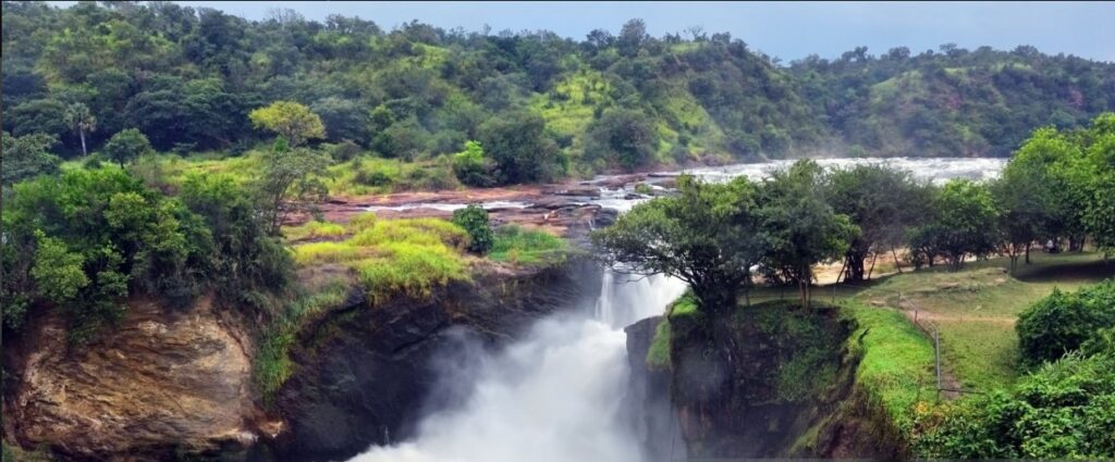 Tourists on 3 Days Murchison Falls Safari viewing wildlife and waterfalls in Uganda.